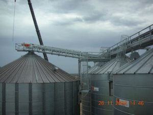 Install overhead load in auger & platform